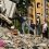 A man looks at inside a collapsed house after an earthquake in Pereira, Colombia on August 11, 2026. Colombian volunteers and rescuers cleared rubble with their bare hands to search for survivors early on August 11 after the country's strongest earthquake in a decade killed at least 169 people and smashed dozens of buildings. (Photo by Luis ACOSTA / AFP)